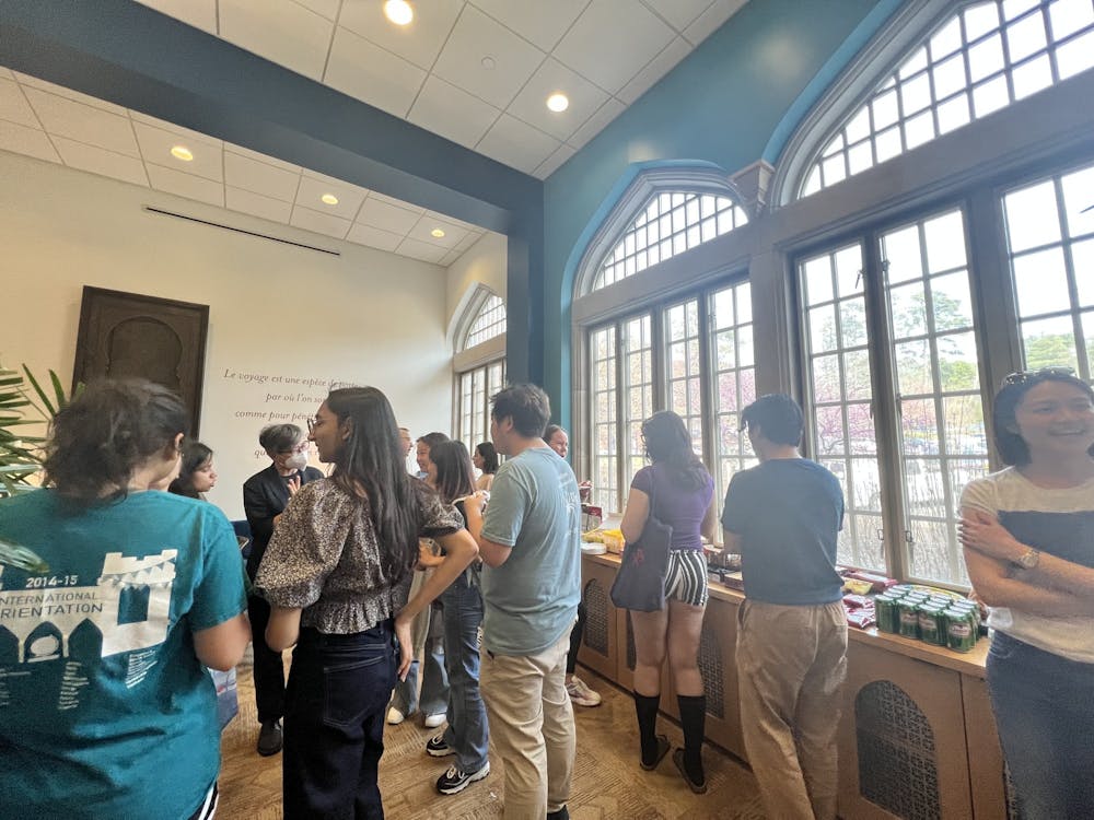 Students hear professor speak on their international experience at the International Office of Education on March 24. 