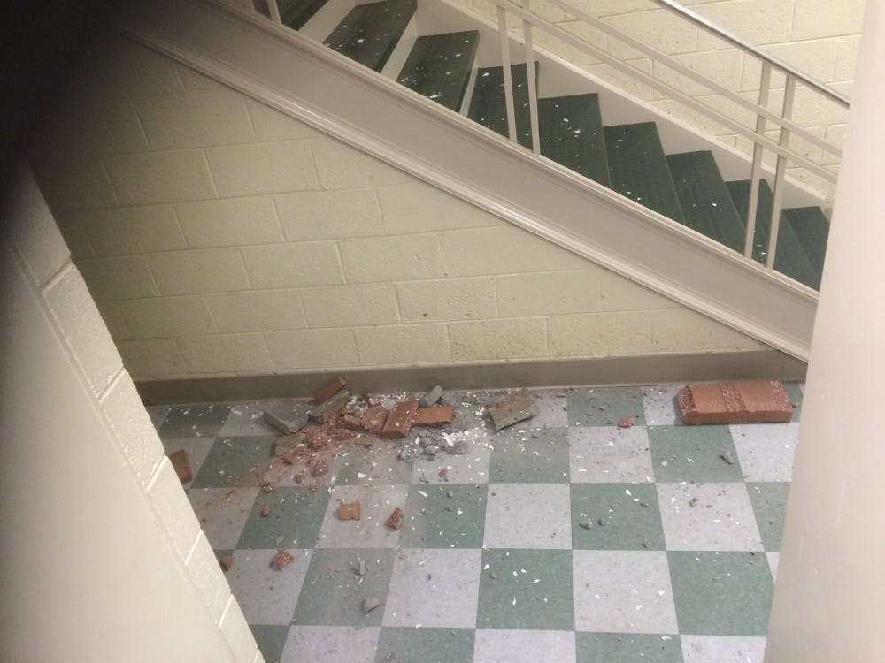 <p>Brick and debris on the floor of South Court. The dorm has experienced high levels of vandalism this year. Photo by Antonio DeMora.</p>