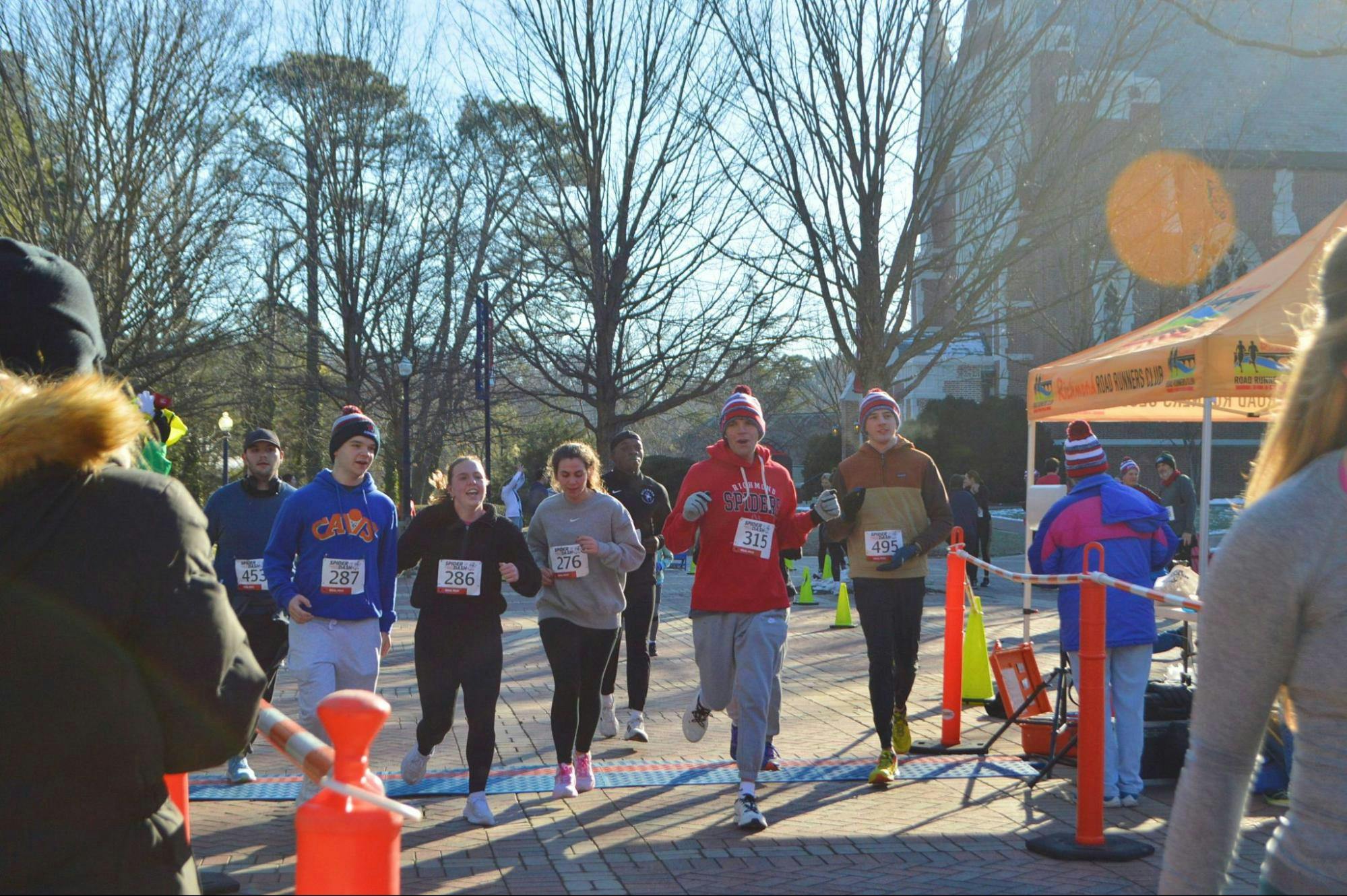 Runners cross the finish line. From left to right: Parker Armstrong, Brian Clark, Grace Van Houtte, Stella Ligammari, Jacob Glenn, Hunter Haney.