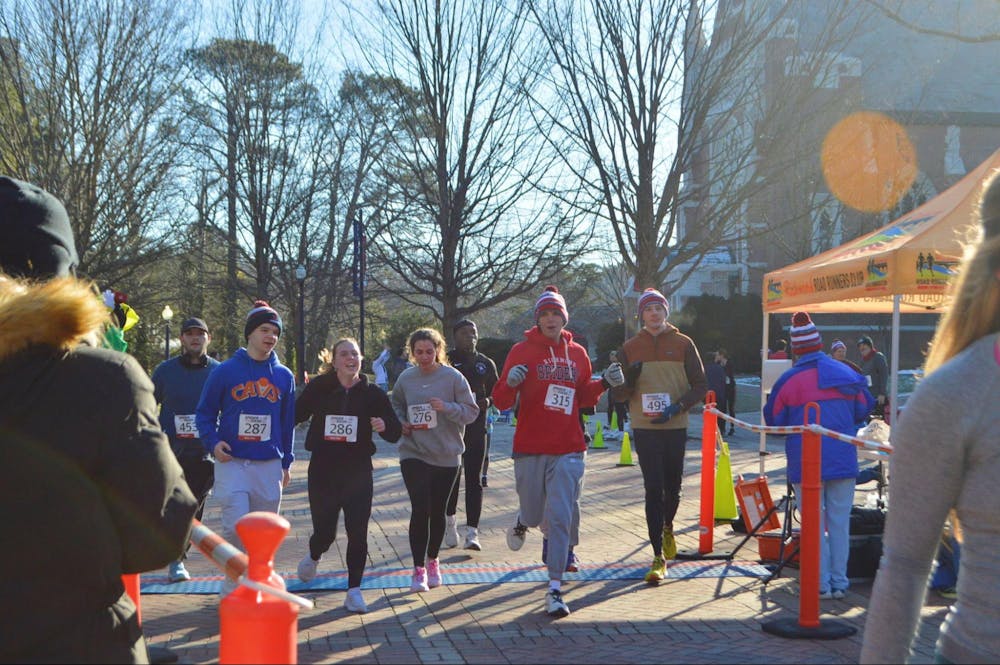 Runners cross the finish line. From left to right: Parker Armstrong, Brian Clark, Grace Van Houtte, Stella Ligammari, Jacob Glenn, Hunter Haney.