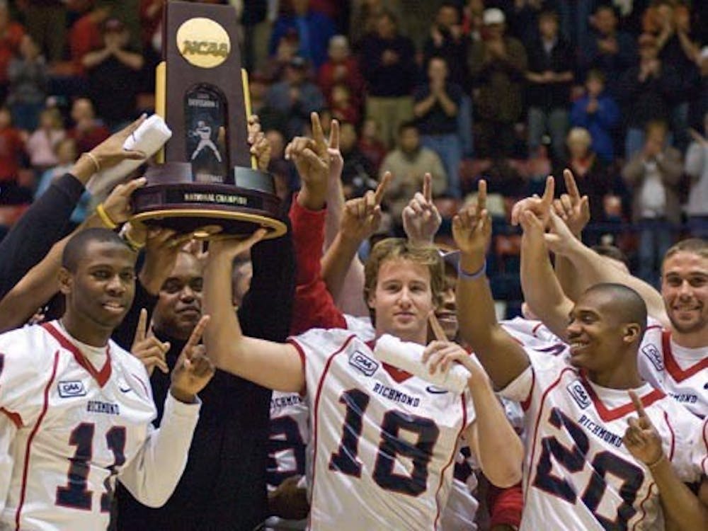 All together: Coach London, the Team, and the Championship Trophy