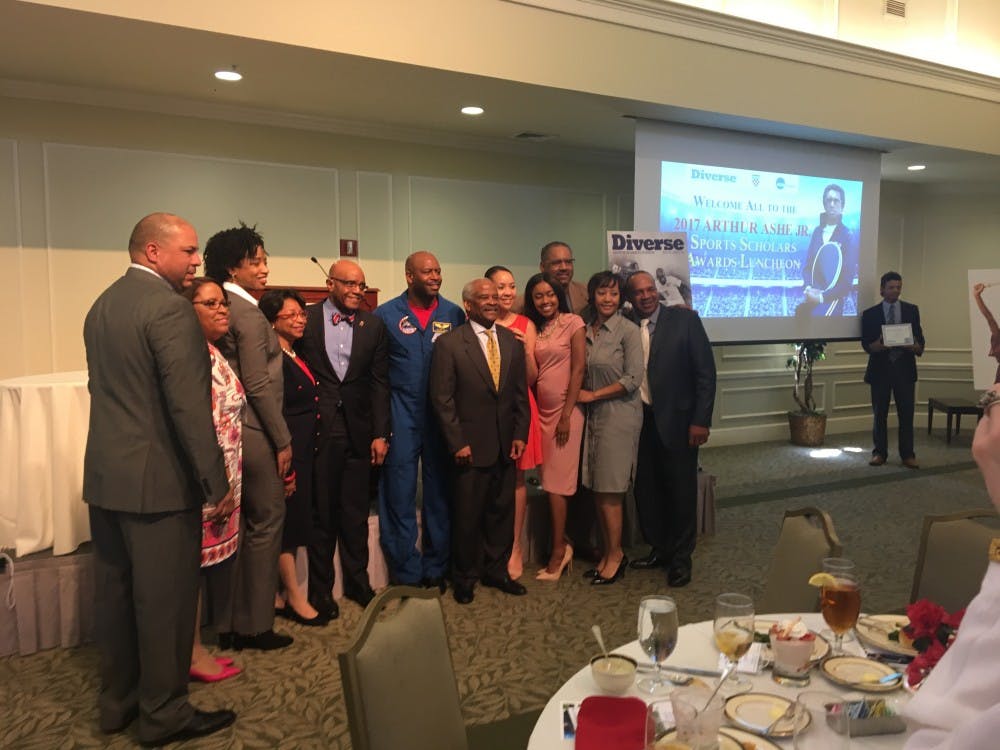 Leland Melvin, pictured above&nbsp;in his blue NASA uniform, stands with Dr. Ronald and Betty Crutcher, along with representatives from the&nbsp;NCAA and Diverse Magazine.&nbsp;