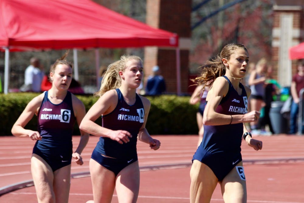 <p>Eryn Mills (center) wins the 3,000m race at the Fred Hardy Invitational on Saturday, March 31. Colleen Carney (right) placed second and Kylie Regan placed fourth.</p>