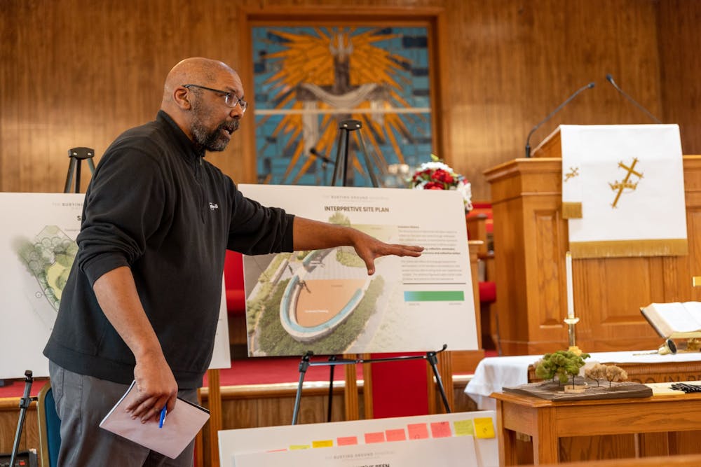 <p>Burt Pinnock demonstrates the Westham Burying Ground memorial site plan to a group of descendants on Feb. 11 at the Pilgrim Journey Baptist Church. Pinnock is the lead architect behind the project and has been holding information sessions for UR community members since 2021.</p>