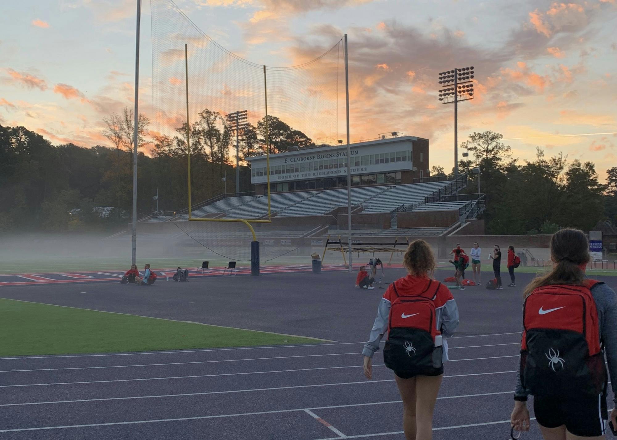 Members on the women's cross country team walk to an early morning practice. Courtesy of Anna George