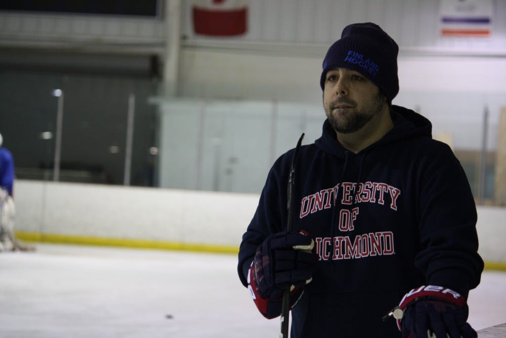 <p>Jason Block, Richmond club hockey's new head coach, watches the team practice drills at SkateNation Plus.&nbsp;</p>
