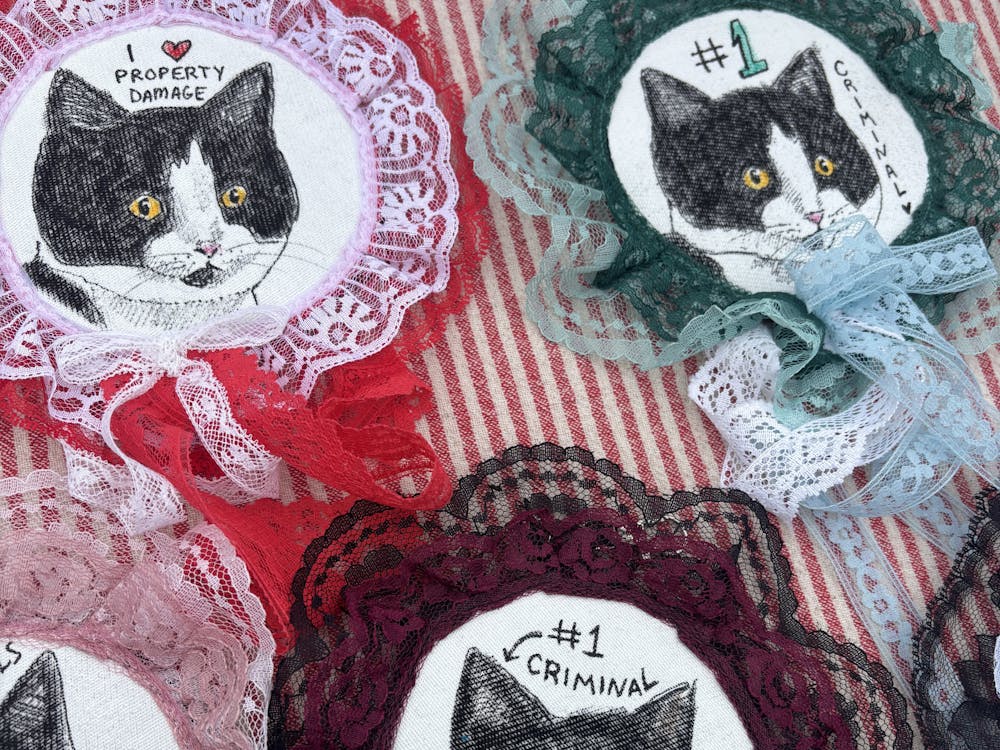 Karina Clemz sewed prize pins of Roll The Dice — the cafe's flood suspect. 