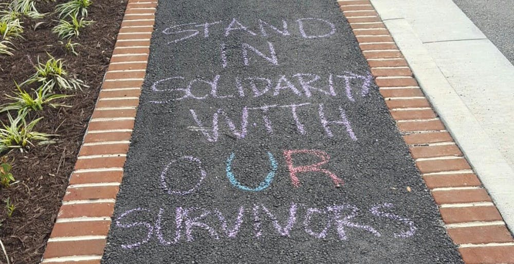 <p>Spiders Against Sexual Assault chalked the sidewalk in front of the new Queally Center.</p>