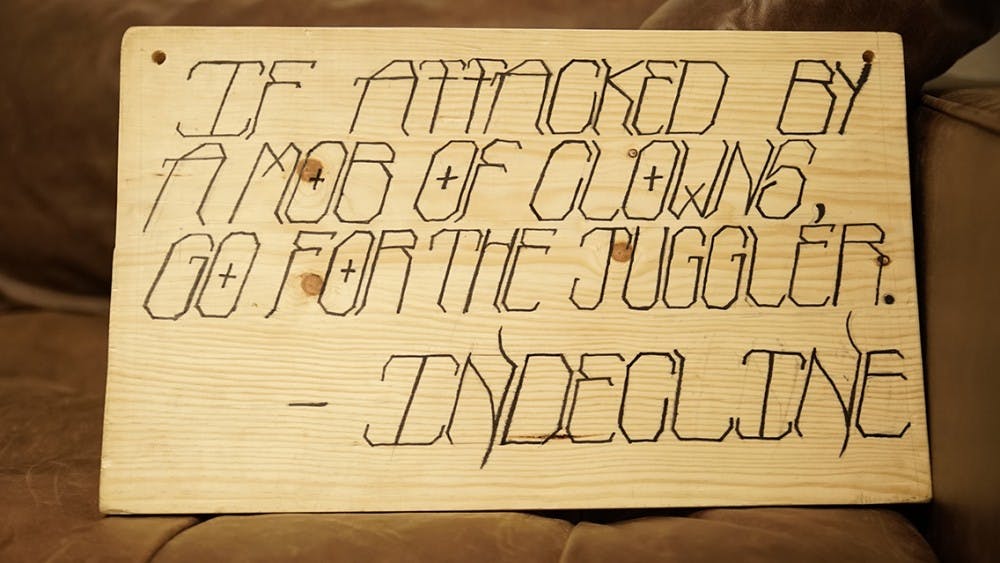 A sign reading: " 'If attacked by a mob of clowns, go for the juggler' -- INDECLINE" was hung around the necks of eight effigies.