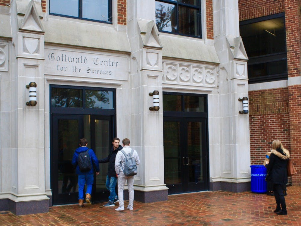 Students enter the Gottwald Science Center, home to the chemistry department.&nbsp;