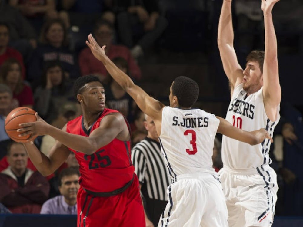 ShawDre' Jones and TJ Cline defend Dayton's Kendall Pollard, who helped the Flyers to a victory against the Spiders in the A-10 Quarterfinals | Photo courtesy of Richmond Athletics