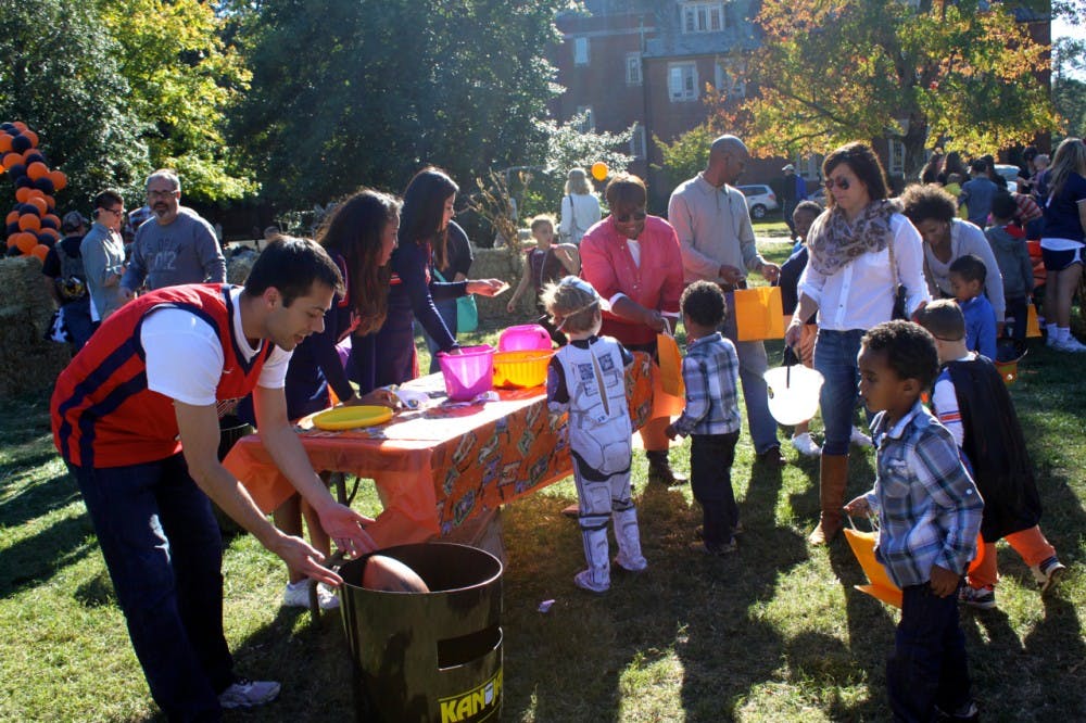 Richmond students and local families enjoy games at candy during Trick or Treat Street (TOTS) on the Westhampton Green.