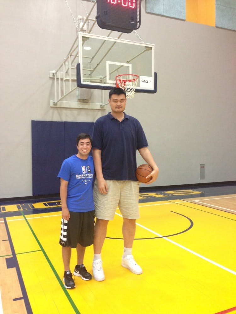 Zachary Chu (left) with Yao Ming at the Basketball Without Borders camp in Taipei, Taiwan.