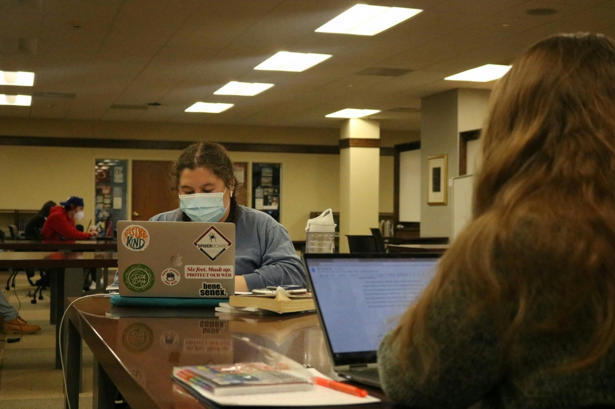 Two students work across from each other in Boatwright Memorial Library.