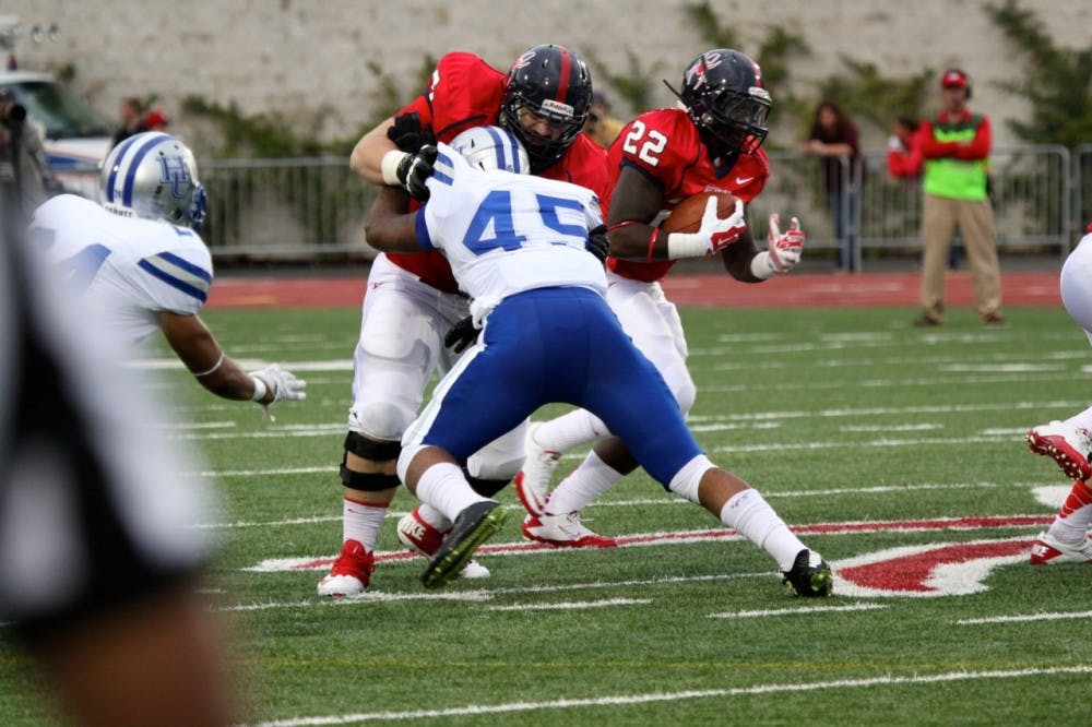 <p>Freshman running back Jeremiah Hamlin carries the ball against Hampton.</p>