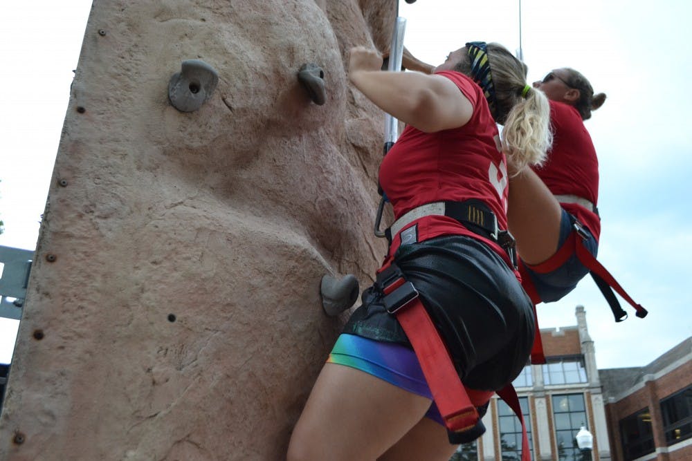 <p>Lauren Gallagher scales the rock climbing wall at SpiderFest.</p>