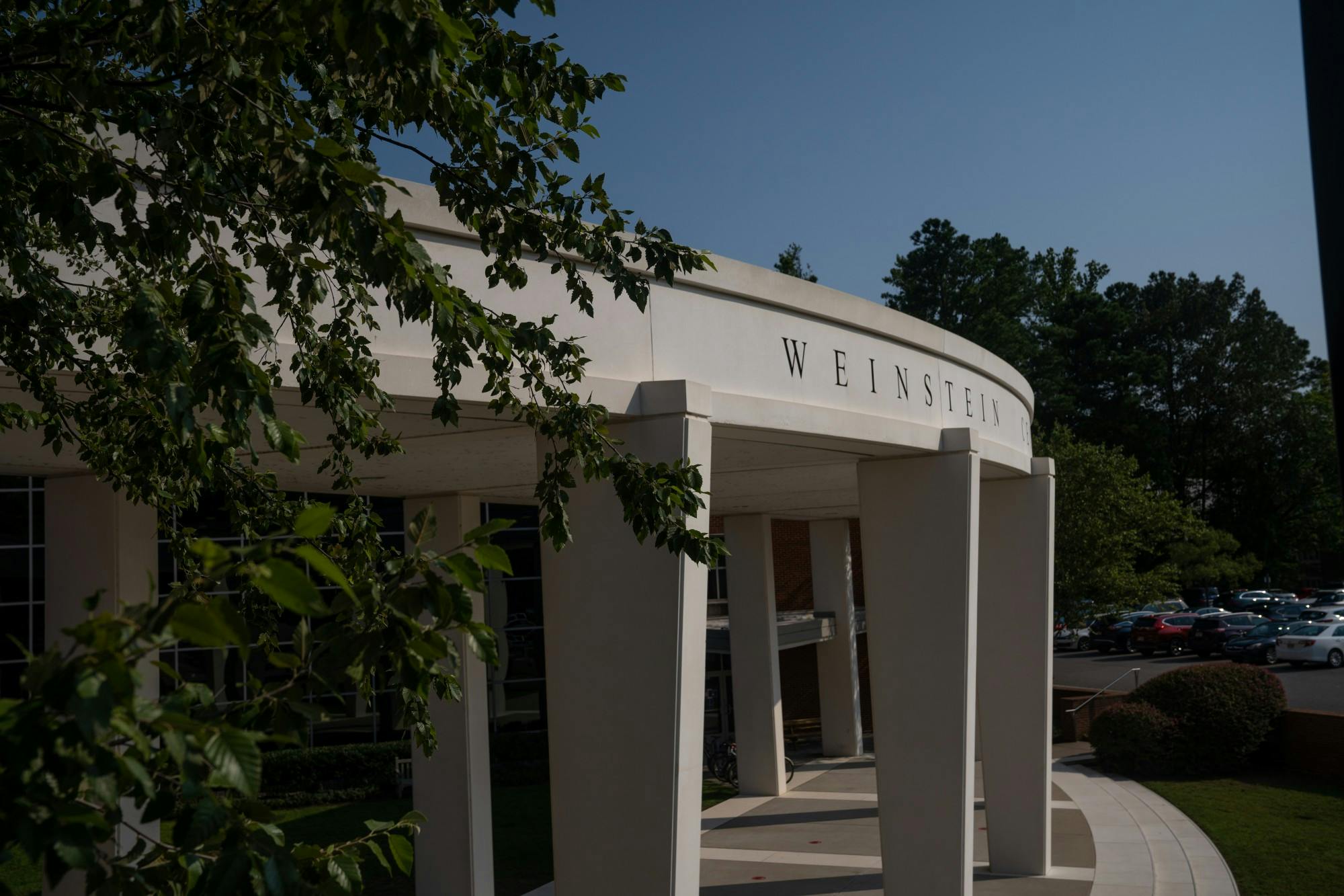 &nbsp;
The archway for the Weinstein Center for Recreation peeks through the brush