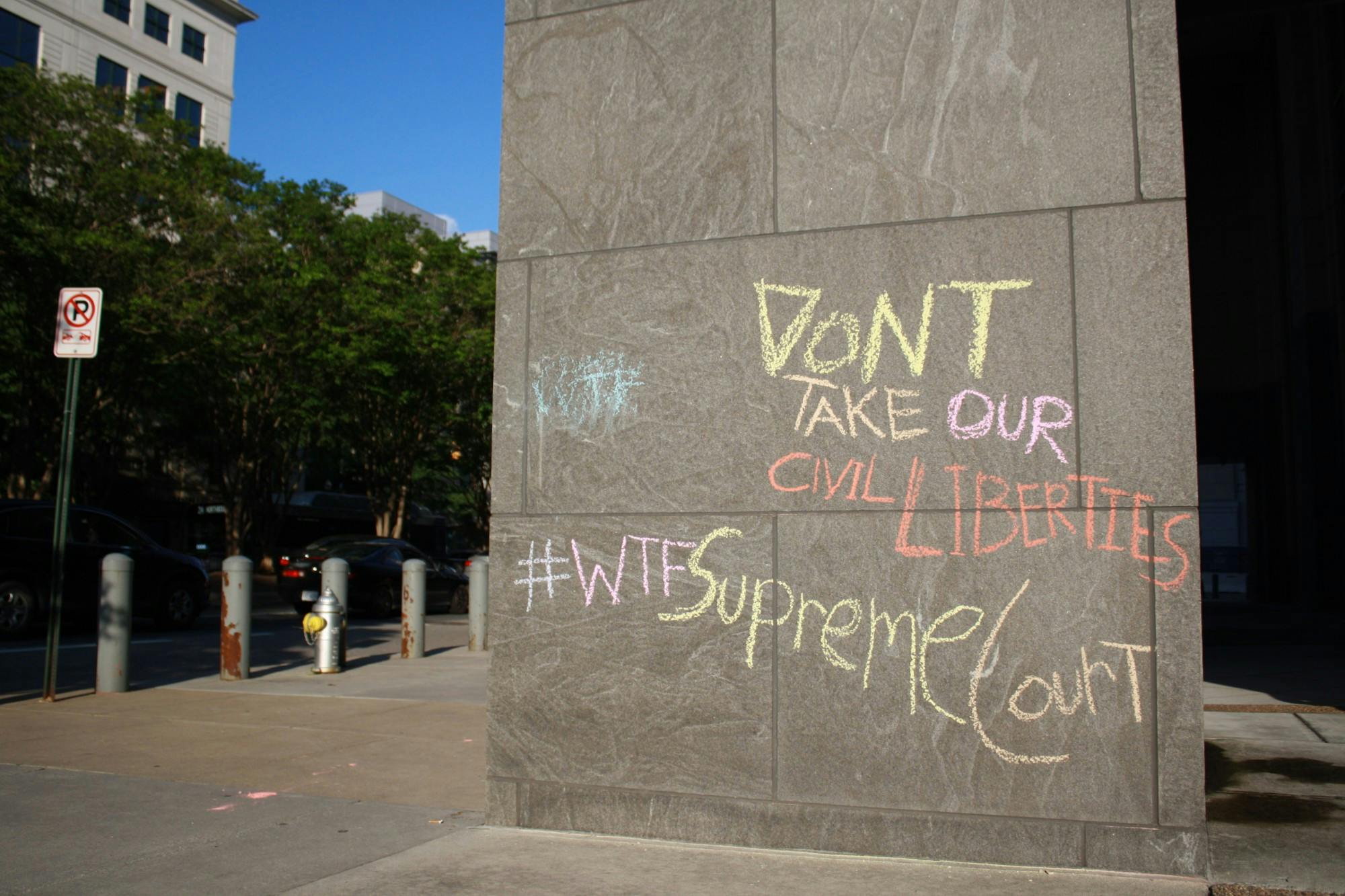 Chalk writing on a building in downtown Richmond.