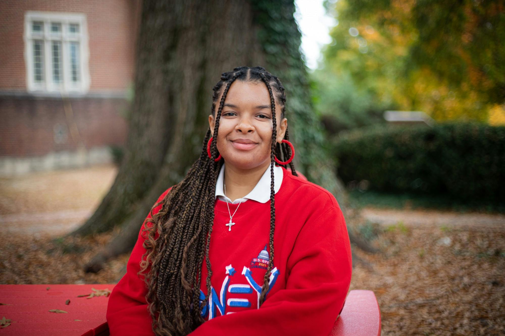 A portrait of senior Sherley Arias-Pimentel in front of the Boatwright Library.&nbsp;