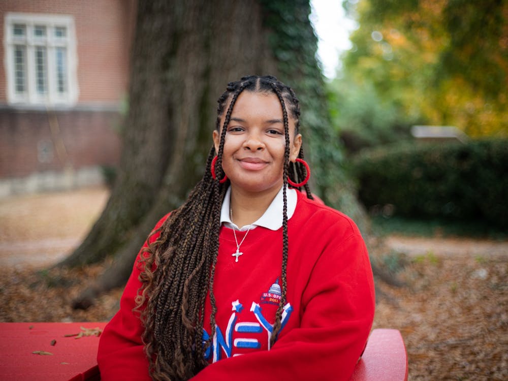 A portrait of senior Sherley Arias-Pimentel in front of the Boatwright Library.&nbsp;