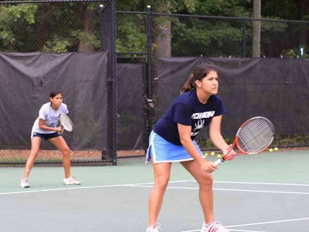 Pamela Duran, '09, and Isabel Arana, '11, playing as doubles partners