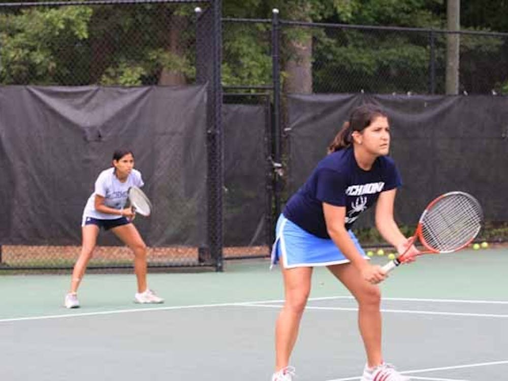Pamela Duran, '09, and Isabel Arana, '11, playing as doubles partners