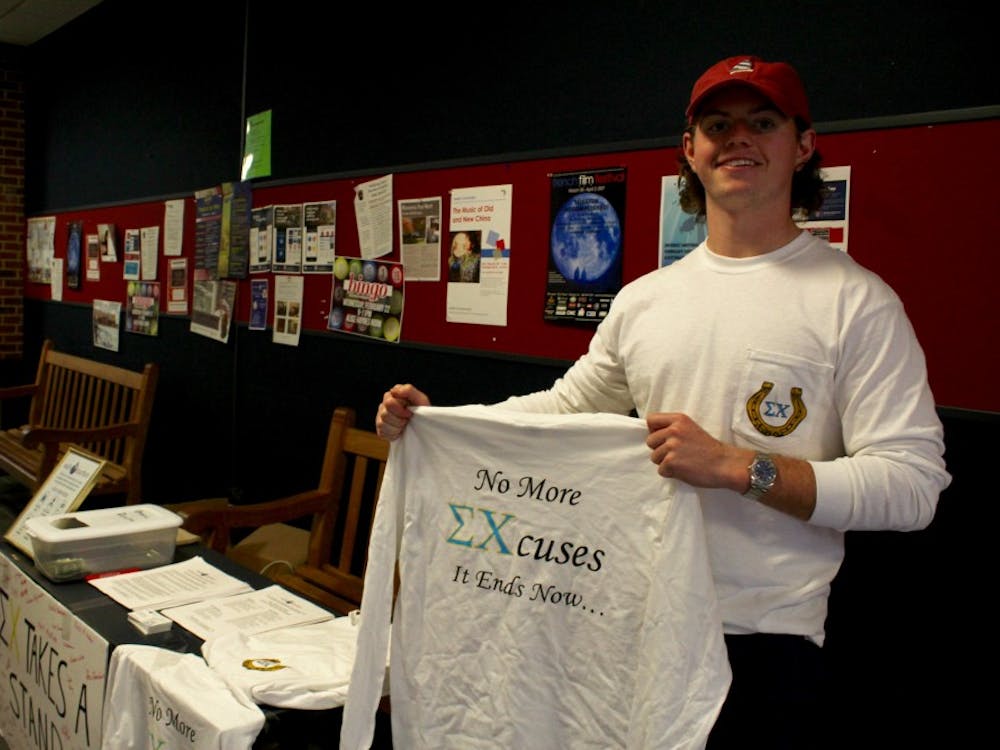 Sigma Chi fraternity member Miller Joyce holds up one of the shirts being sold&nbsp;in the Commons this week.