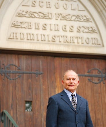 Bob Schmidt, interim dean of the busines school, poses for a portrait outside the entrance to the Robins School of Business. Time: 9:30 am, Saturday