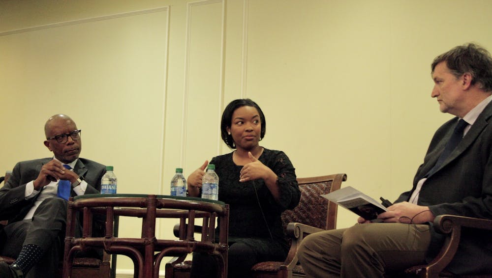 <p>Michael Paul Williams, Ayesha Rascoe and Thad Williamson discuss the intersection of truth and journalism in the Jepson Alumni Center.&nbsp;</p>