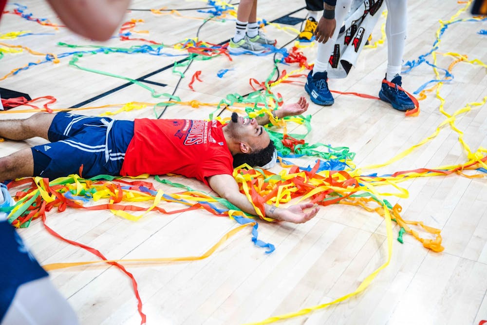 <p>Graduate guard Jacob Gilyard lays on the court to celebrate the Spiders' victory in the Atlantic 10 Championship on March 13 in the Capital One Arena in Washington D.C. Photo courtesy of the Richmond Ahtletics.</p>