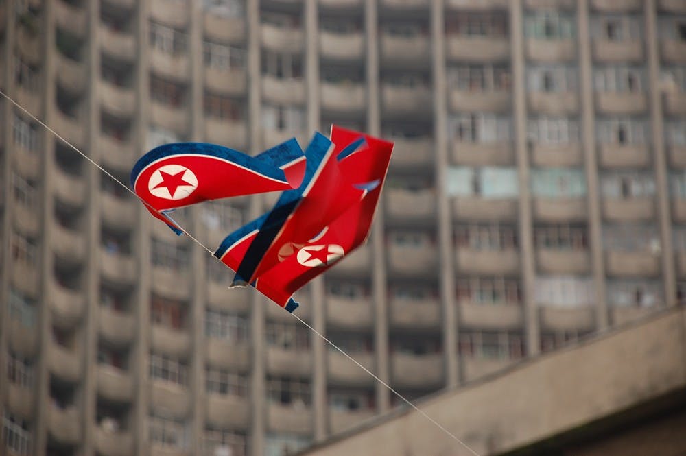 Flags wave in Pyongyang, North Korea. Courtesy of Creative Commons.