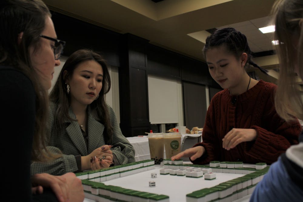 Reilly Geritz (L), Yanran Li and Nicole Liu play Mahjong at the Lunar New Year celebration.