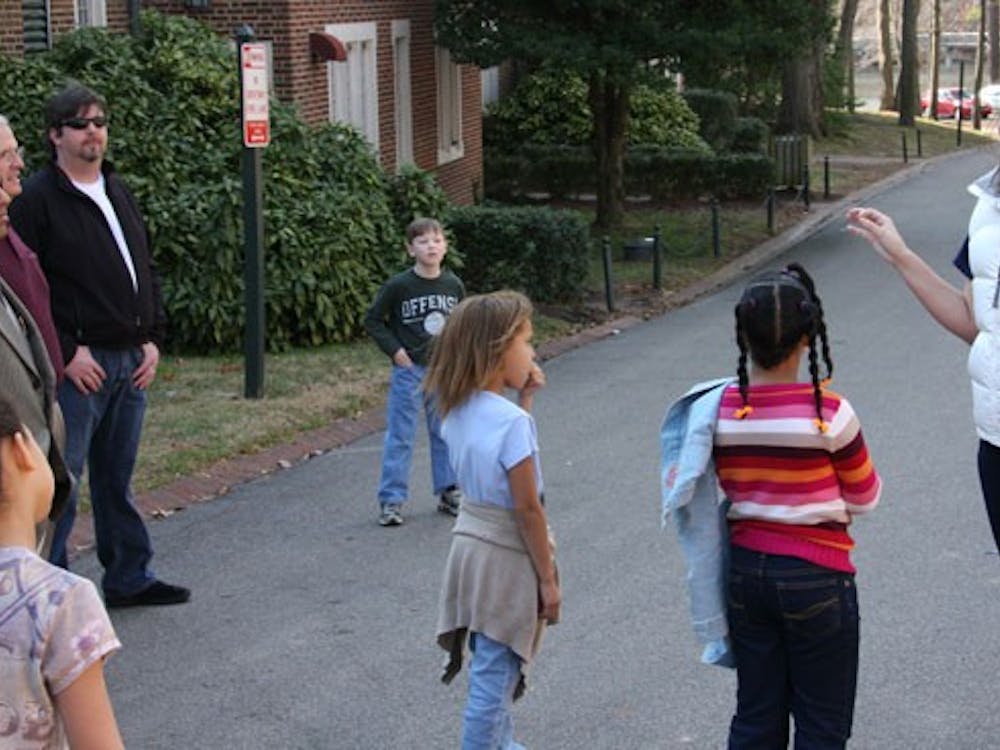 Caroline Vincent, '11, begins a tour around campus for the children