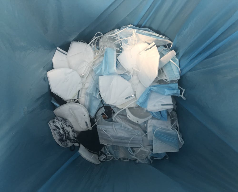<p>Disposable masks inside recycling box in Tyler Haynes Commons.</p>