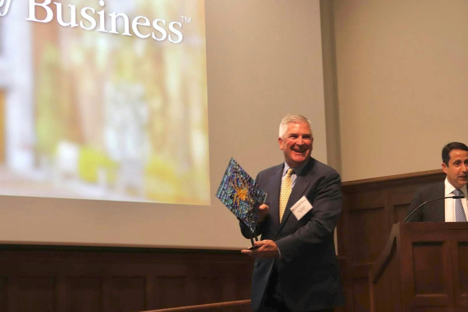 Stephen J. Kneeley accepts a memento as they induct him into the E. Claiborne Robins School of Business Hall of Fame on Nov. 3, 2022.