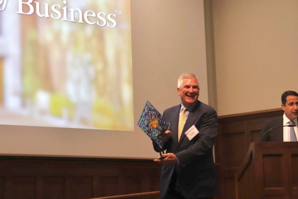 <p>Stephen J. Kneeley accepts a memento as they induct him into the E. Claiborne Robins School of Business Hall of Fame on Nov. 3, 2022.</p>