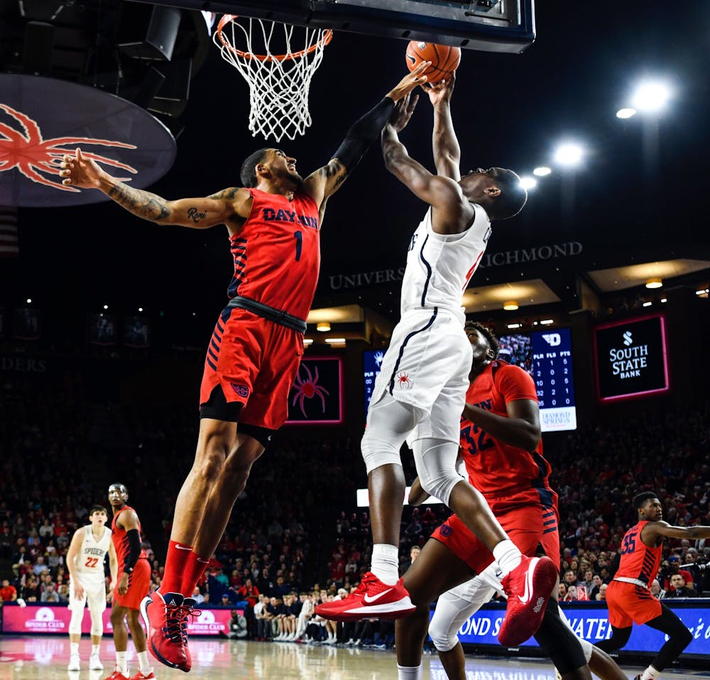 <p>The Dayton Flyers' forward Obadiah Toppin attempts to block a shot by the Richmond Spiders' forward Nathan Cayo during a game at the Robins Center on Saturday, Jan. 25, 2020.&nbsp;</p>