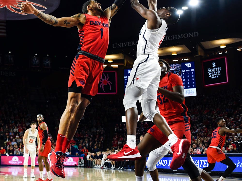 The Dayton Flyers' forward Obadiah Toppin attempts to block a shot by the Richmond Spiders' forward Nathan Cayo during a game at the Robins Center on Saturday, Jan. 25, 2020.&nbsp;