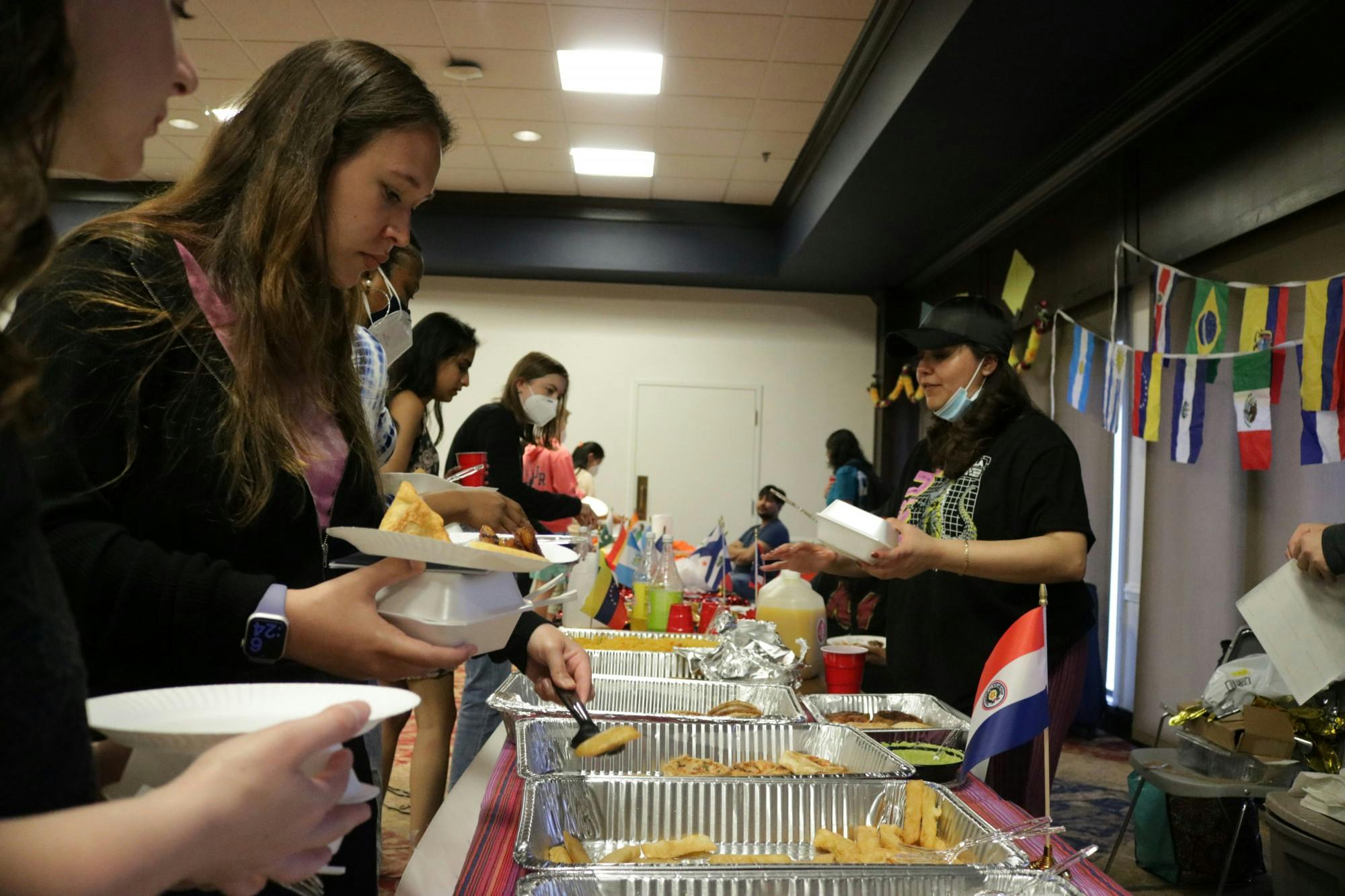 Students get food from the Solidarity Organization for Latinx Students table at "A Taste of the World" on April 16.