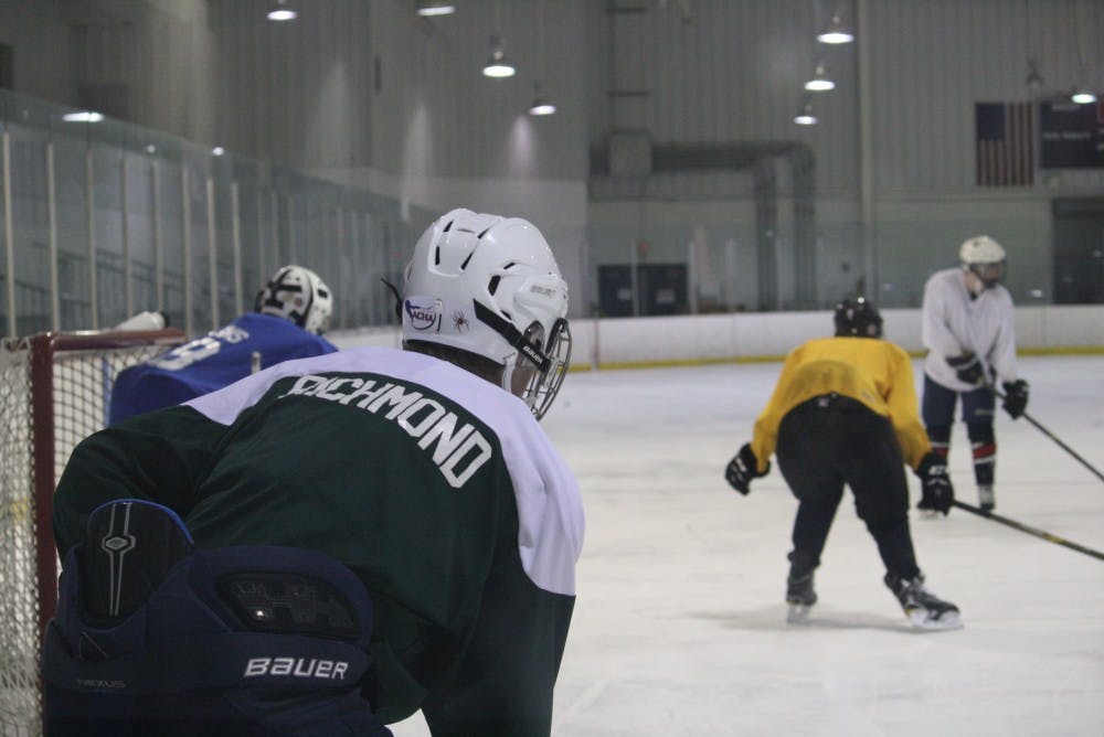 The club hockey team runs a drill during practice.&nbsp;