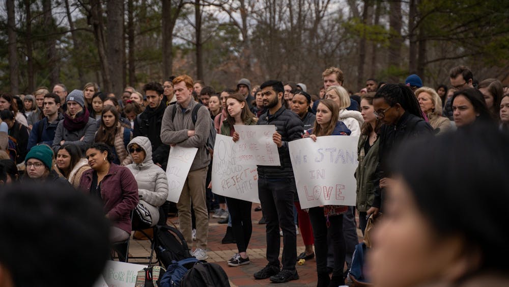 Students stand in the Forum at "More Than Just a Message," an open mic protest aimed at denouncing racist actions that occur on campus. The event took place on Tuesday, Jan. 28, 2020.