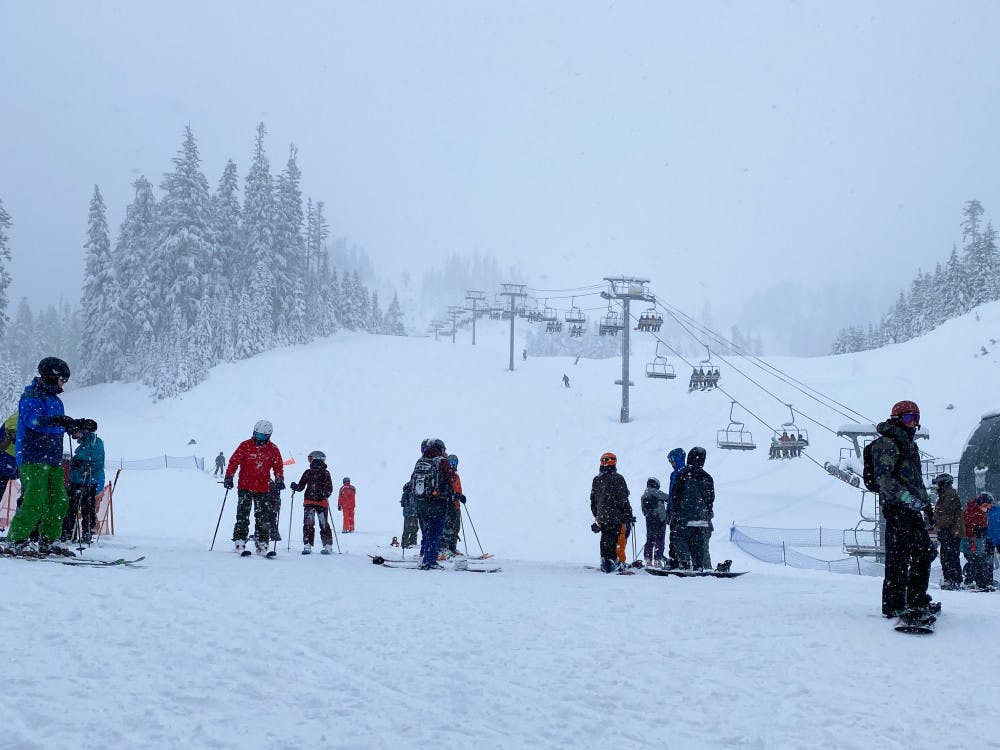 Skiers wait for lift chairs