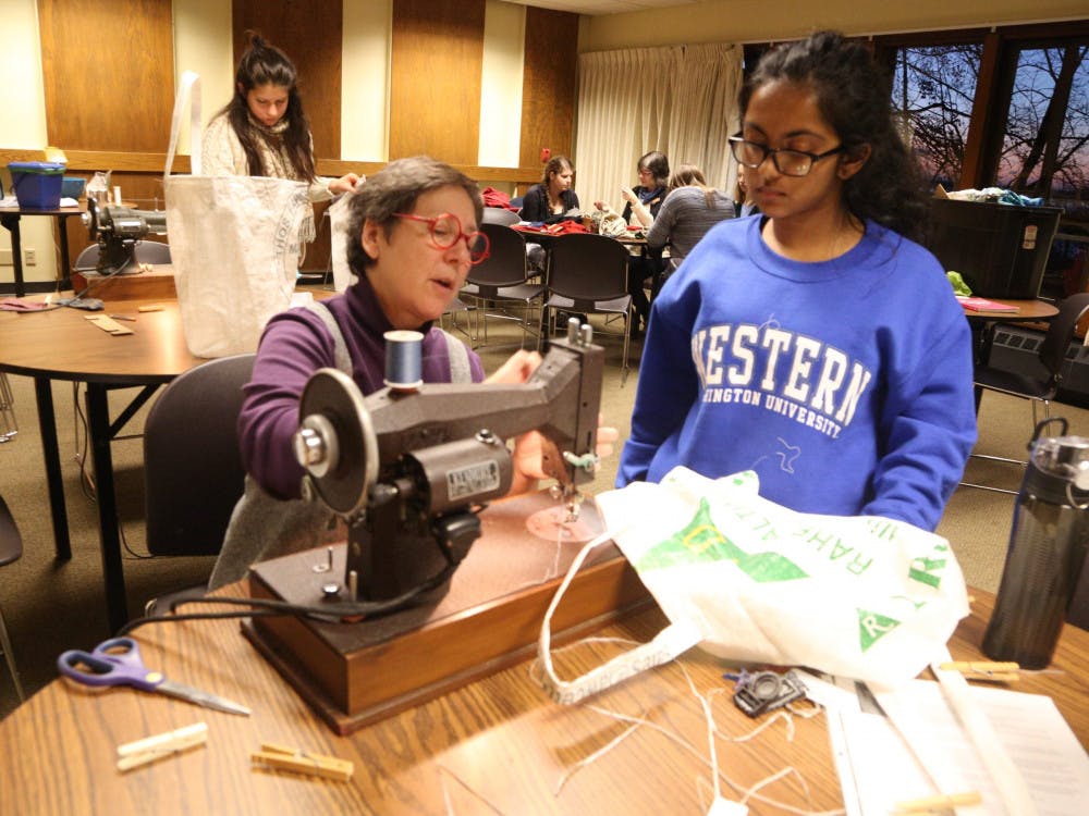 Carol-Berry-of-the-Office-of-Sustainabitly-helping-Niveda-Ganesh-scaled