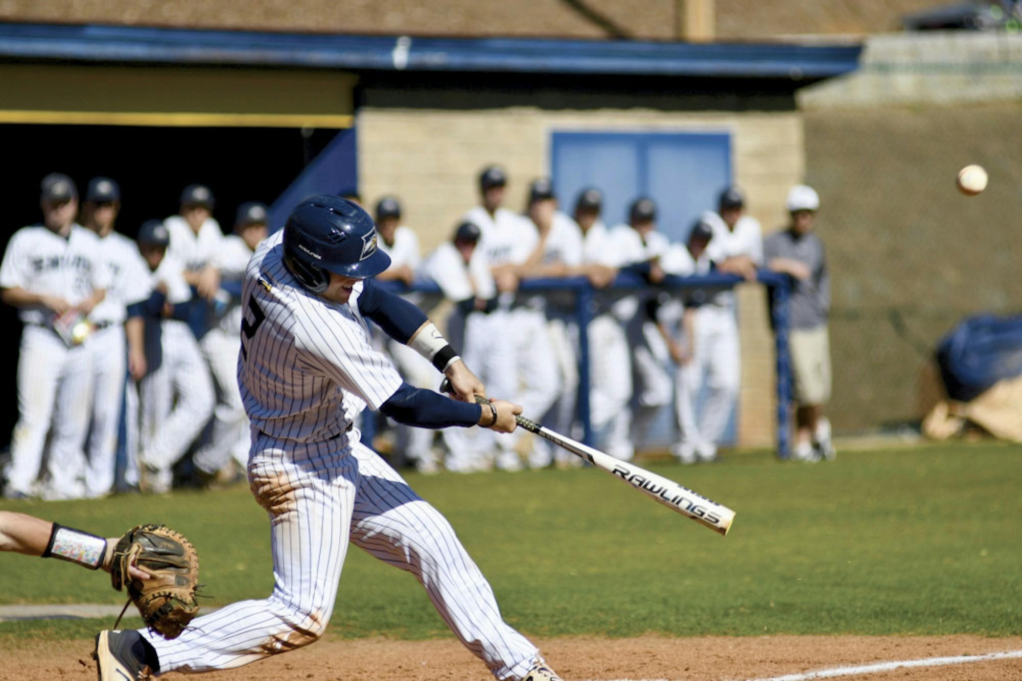 Junior shortstop Nick Chambers connects on a single to left center in the Eagles' game Friday against Huntingdon (Ala.). Chambers' 2 RBIs lifted Emory to a 12-7 victory. Photo courtesy Gemy Sethaputra.