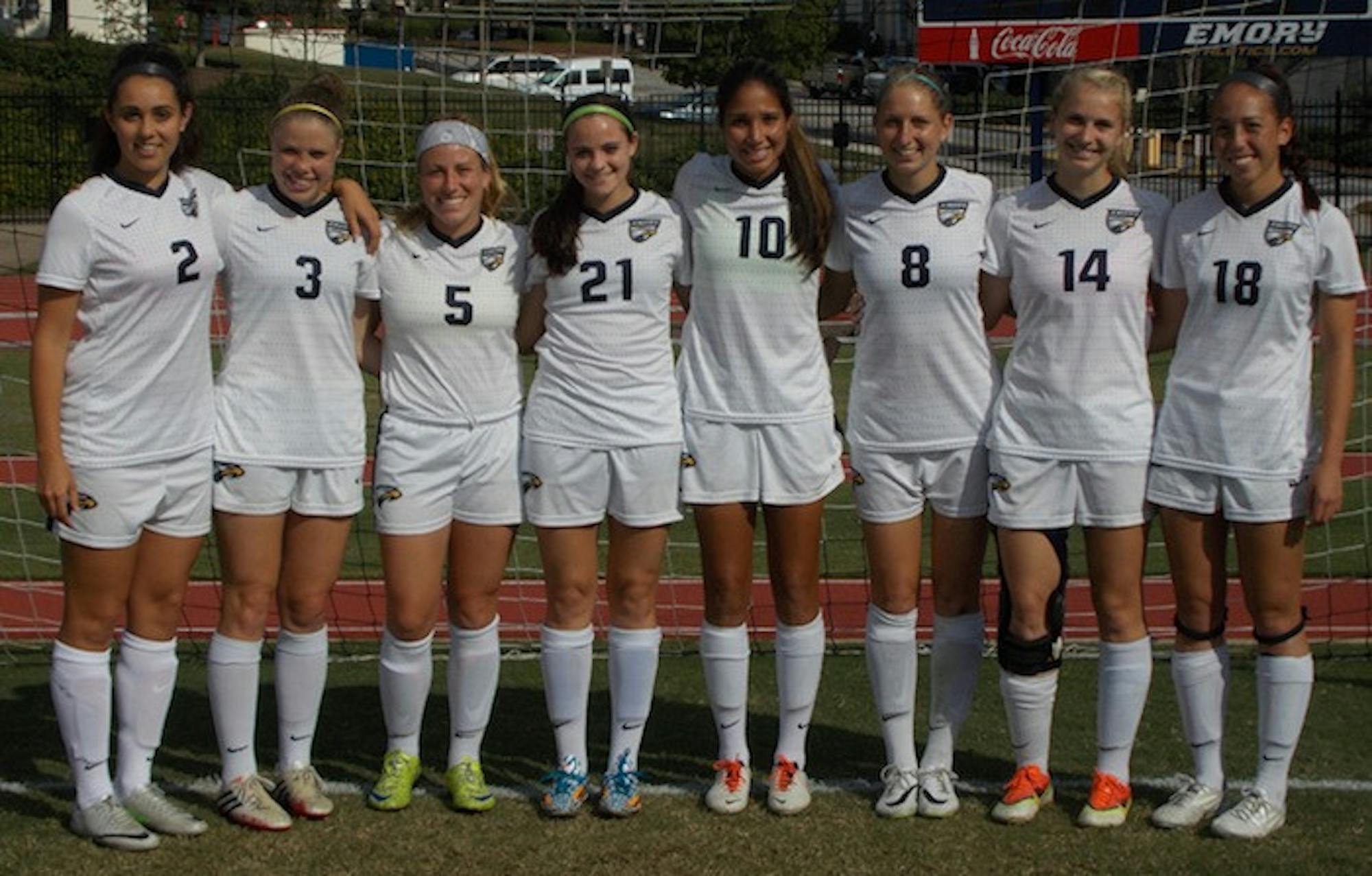 (From left to right) Seniors Claudia Rowe, Charlotte Butker, Emily Feldman, Jennifer Grant, Karina Rodriguez, Meredith Doherty, Sarah Kuel and Kaelyn Lucas pose at their Senior Day game against the University of Rochester (N.Y.) last Friday. | Photo courtesy of Emory Athletics