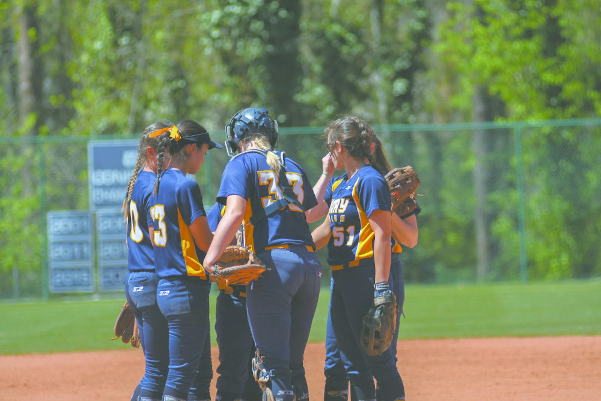 The team huddles around sophomore catcher Lana Herrmann for a quick conference. Gemy Sethaputra/Senior Staff.