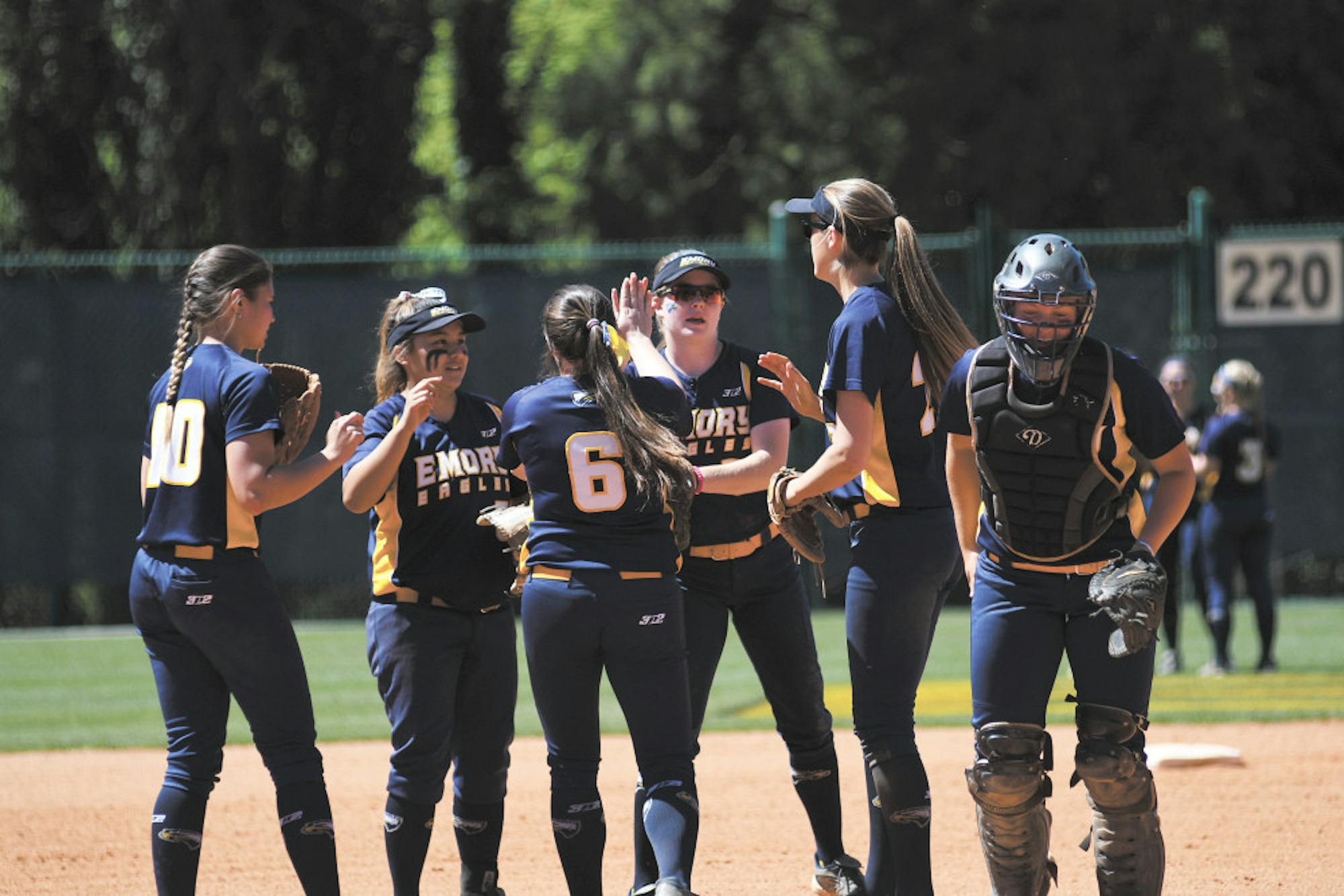 The infield celebrates around senior pitcher Brittany File (center). Gemy Sethaputra/Senior Staff.