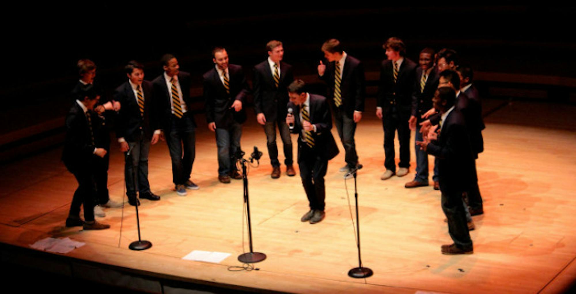 No Strings Attached (NSA) President Jason Charles (center) leads the group in an a cappella rendition of Earth,  Wind & Fire's