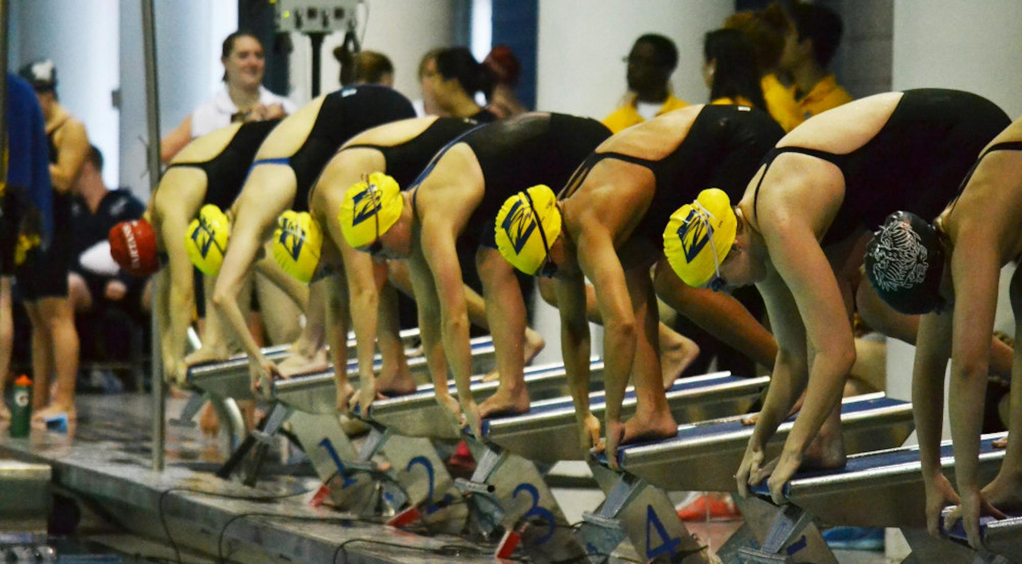 Emory women swimmers prepare to dive into the water. The women’s team, in addition to the men’s team, won the University Athletics Association  (UAA) Championships for the second year in a row.  | Erin Baker/Staff