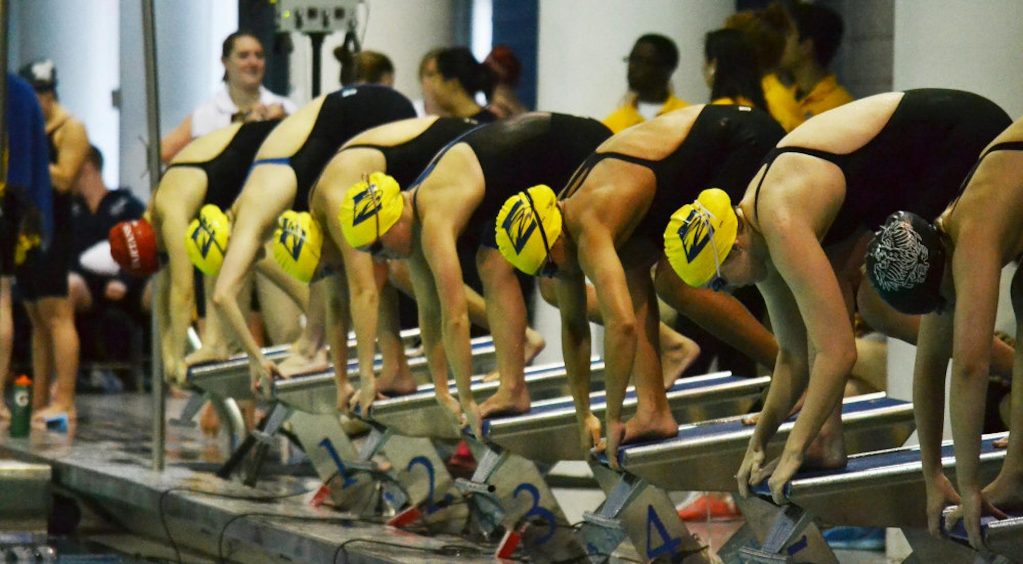 Emory women swimmers prepare to dive into the water. The women’s team, in addition to the men’s team, won the University Athletics Association (UAA) Championships for the second year in a row. | Erin Baker/Staff
